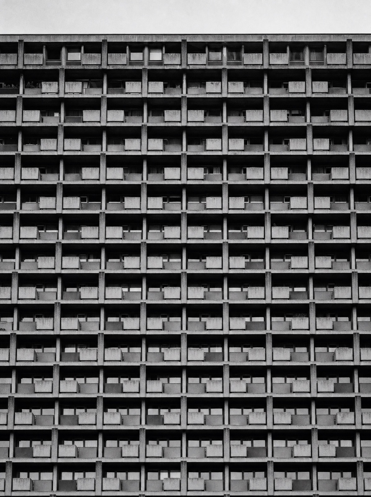 Repeating grid facade of concrete balconies on a mass housing block